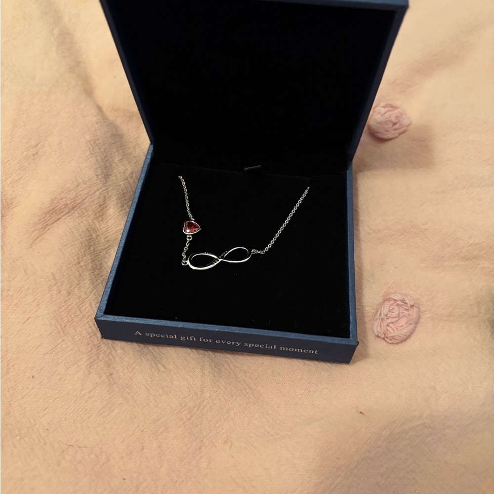 Elegant Silver Infinity Bracelet with Red Accent